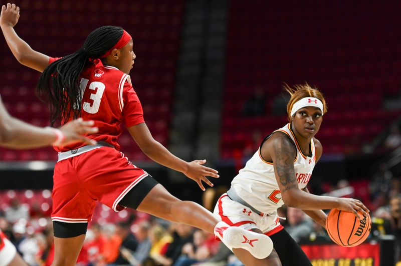 Feb 29, 2024; College Park, Maryland, USA;  Maryland Terrapins guard Bri McDaniel (24) passes beyond Wisconsin Badgers guard Ronnie Porter (13) foot during the second half at Xfinity Center. Mandatory Credit: Tommy Gilligan-USA TODAY Sports