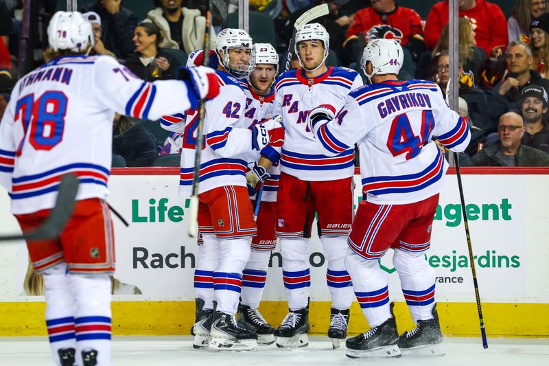 Oct 26, 2025; Calgary, Alberta, CAN; New York Rangers center Noah Laba (42) celebrates his goal with teammates against the Calgary Flames during the first period at Scotiabank Saddledome. Mandatory Credit: Sergei Belski-Imagn Images