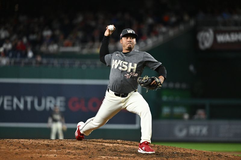 Sep 27, 2024; Washington, District of Columbia, USA;  Washington Nationals pitcher Robert Garcia (61) delivers a seventh inning pitch against the Philadelphia Phillies at Nationals Park. Mandatory Credit: James A. Pittman-Imagn Images