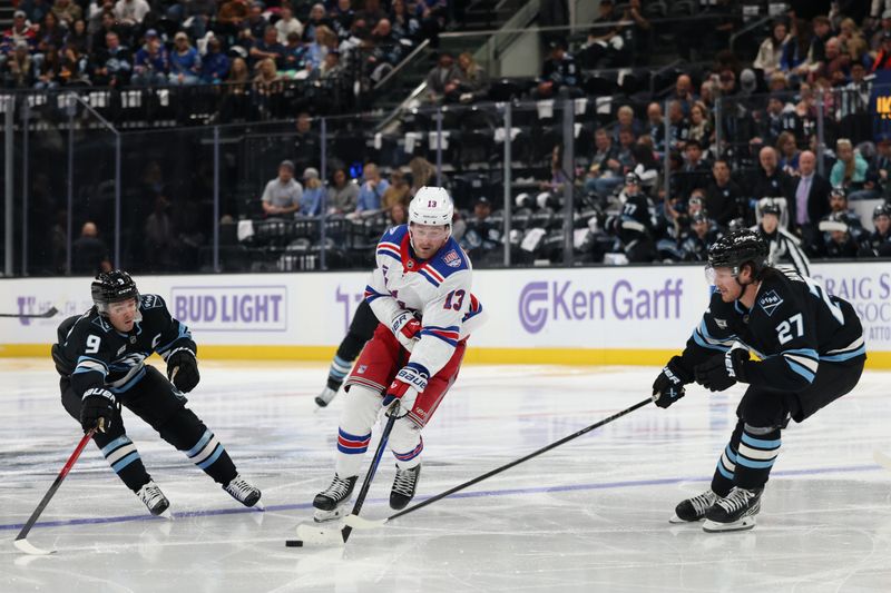 Nov 22, 2025; Salt Lake City, Utah, USA; New York Rangers left wing Alexis Lafreniere (13) skates against Utah Mammoth right wing Clayton Keller (9) and center Barrett Hayton (27) during the second period at Delta Center. Mandatory Credit: Rob Gray-Imagn Images