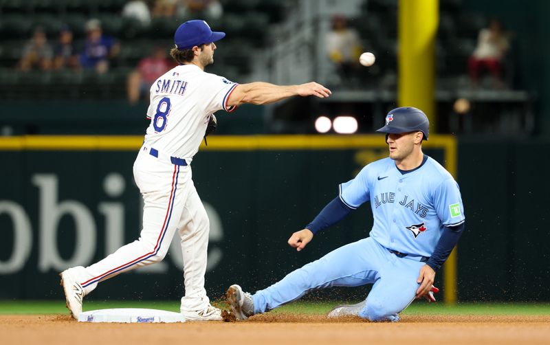 May 28, 2025; Arlington, Texas, USA; Texas Rangers shortstop Josh Smith (8) forces out Toronto Blue Jays center fielder Daulton Varsho (5) at second base and completes a double play during the first inning at Globe Life Field. Mandatory Credit: Kevin Jairaj-Imagn Images