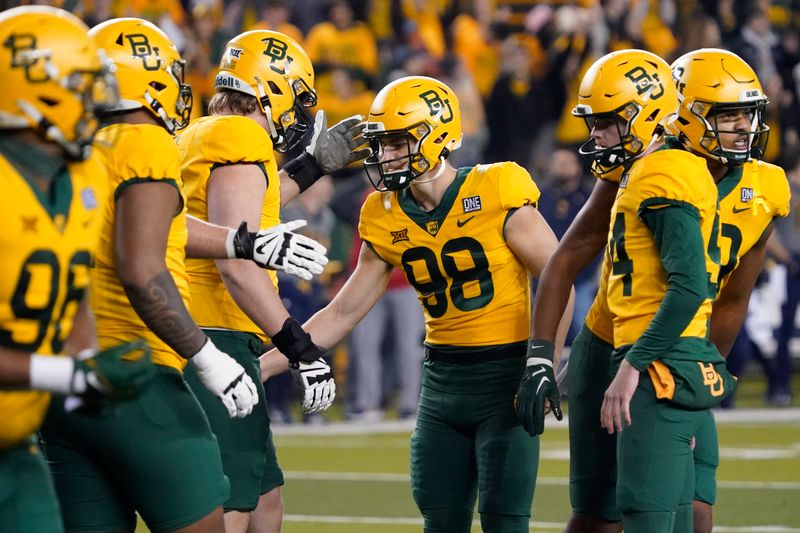 Nov 25, 2023; Waco, Texas, USA; Baylor Bears place kicker Isaiah Hankins (98) is congratulated by teammates after kicking a  39-yard field goal during the second half against the West Virginia Mountaineers at McLane Stadium. Mandatory Credit: Raymond Carlin III-USA TODAY Sports