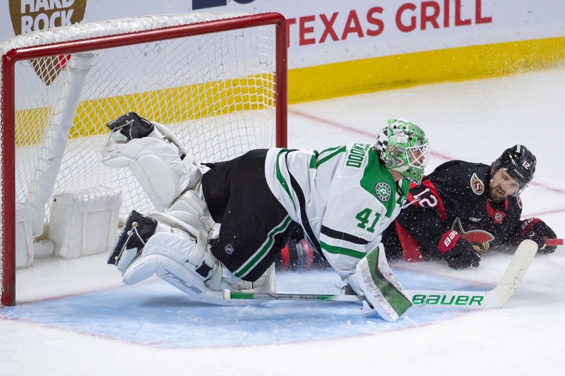 Feb 22, 2024; Ottawa, Ontario, CAN; Ottawa Senators center Mark Kastelic (12) slides into Dallas Stars goalie Scott Wedgewood (41) in the third period at the Canadian Tire Centre. Mandatory Credit: Marc DesRosiers-USA TODAY Sports