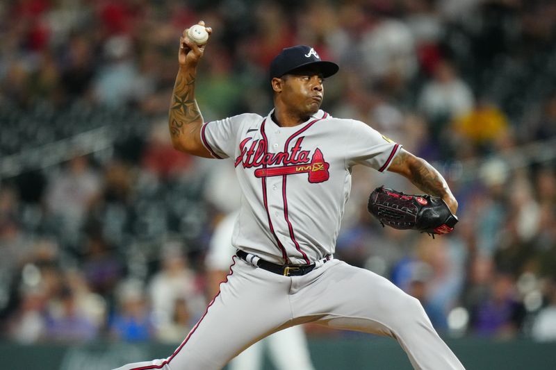 Aug 30, 2023; Denver, Colorado, USA; Atlanta Braves relief pitcher Raisel Iglesias (26) delivers a pitch in the ninth inning against the Colorado Rockies at Coors Field. Mandatory Credit: Ron Chenoy-USA TODAY Sports