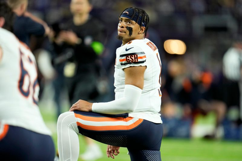 Chicago Bears quarterback Justin Fields (1) stretches before an NFL football game against the Minnesota Vikings, Monday, Nov. 27, 2023, in Minneapolis. (AP Photo/Abbie Parr)