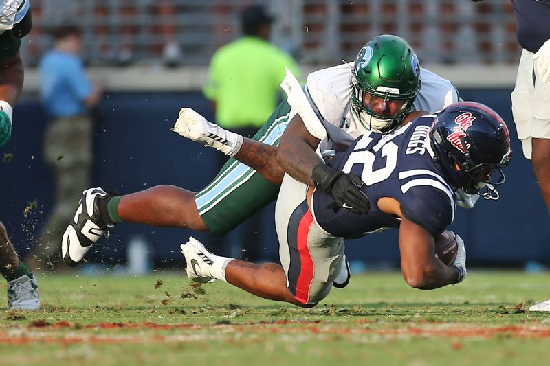 Sep 20, 2025; Oxford, Mississippi, USA; Tulane Green Wave defensive linemen Eliyt Nairne (90) tackles Mississippi Rebels running back Logan Diggs (22) during the fourth quarter at Vaught-Hemingway Stadium. Mandatory Credit: Petre Thomas-Imagn Images