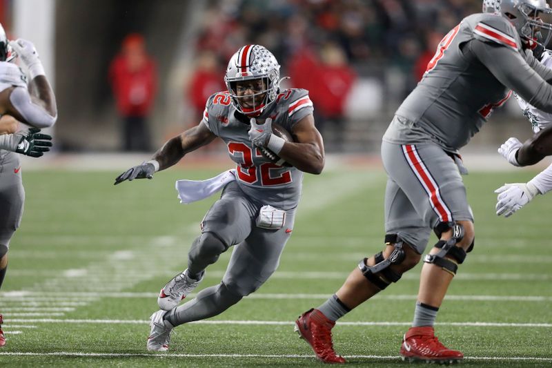 Nov 11, 2023; Columbus, Ohio, USA; Ohio State Buckeyes running back TreVeyon Henderson (32) runs the ball during the second quarter against the Michigan State Spartans at Ohio Stadium. Mandatory Credit: Joseph Maiorana-USA TODAY Sports