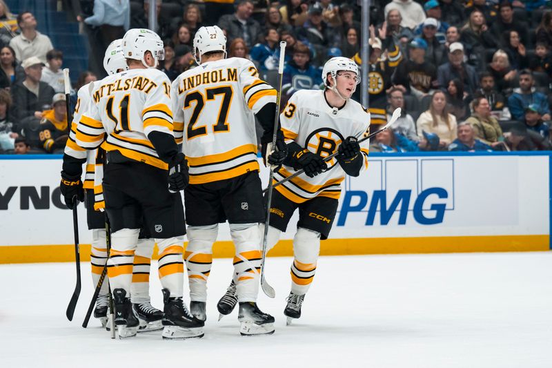 Jan 3, 2026; Vancouver, British Columbia, CAN; Boston Bruins forward Fraser Minten (93) celebrates with forward Casey Mittelstadt (11) and defenseman Hampus Lindholm (27) after scoring a goal against the Vancouver Canucks in the first period at Rogers Arena. Mandatory Credit: Bob Frid-Imagn Images