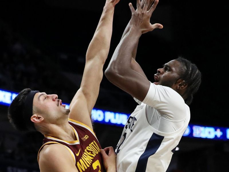 Jan 27, 2024; University Park, Pennsylvania, USA; Penn State Nittany Lions forward Qudus Wahab (22) shoots as Minnesota Golden Gophers forward Dawson Garcia (3) defends during the first half at Bryce Jordan Center. Mandatory Credit: Matthew O'Haren-USA TODAY Sports