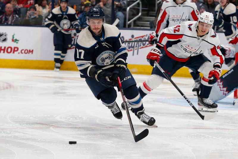 Dec 21, 2023; Columbus, Ohio, USA; Columbus Blue Jackets right wing Justin Danforth (17) tracks down a loose puck as Washington Capitals defenseman Martin Fehervary (42) trails the play during the third period at Nationwide Arena. Mandatory Credit: Russell LaBounty-USA TODAY Sports