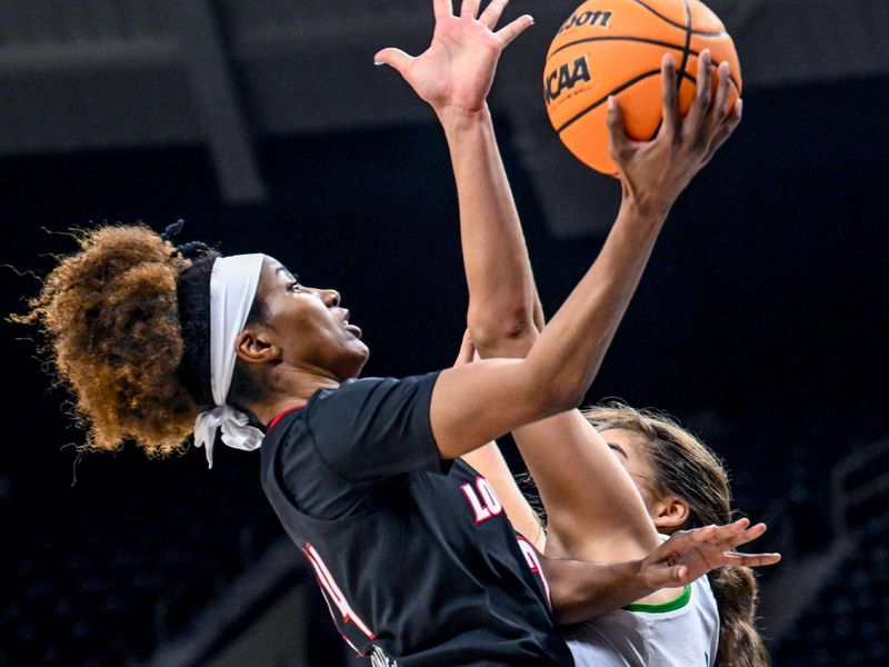 Feb 16, 2023; South Bend, Indiana, USA; Louisville Cardinals guard Morgan Jones (24) goes up for a shot as Notre Dame Fighting Irish forward Maddy Westbeld (21) defends in the first half at the Purcell Pavilion. Mandatory Credit: Matt Cashore-USA TODAY Sports