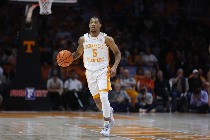 Jan 6, 2024; Knoxville, Tennessee, USA; Tennessee Volunteers guard Zakai Zeigler (5) brings the ball up court against the Mississippi Rebels during the first half at Thompson-Boling Arena at Food City Center. Mandatory Credit: Randy Sartin-USA TODAY Sports