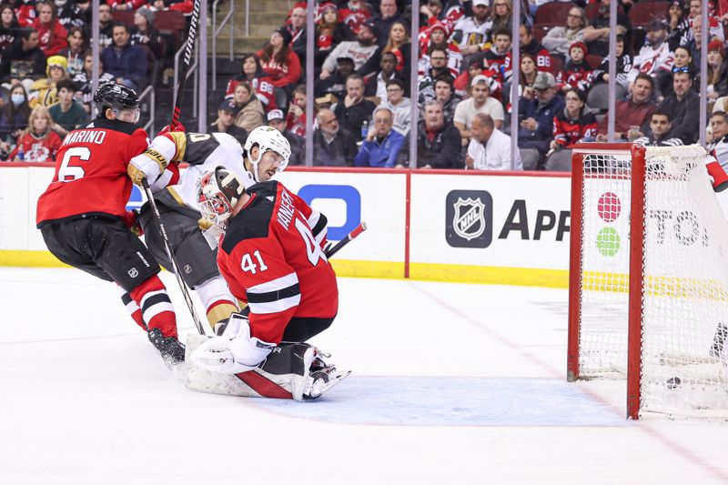 Jan 22, 2024; Newark, New Jersey, USA; Vegas Golden Knights center Chandler Stephenson (20) scores a goal past New Jersey Devils goaltender Vitek Vanecek (41) while defended by defenseman John Marino (6) during the second period at Prudential Center. Mandatory Credit: Vincent Carchietta-USA TODAY Sports