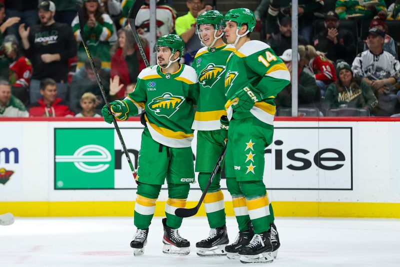 Dec 3, 2023; Saint Paul, Minnesota, USA; Minnesota Wild left wing Matt Boldy (12) celebrates his goal with right wing Mats Zuccarello (36) and center Joel Eriksson Ek (14) during the second period against the Chicago Blackhawks at Xcel Energy Center. Mandatory Credit: Matt Krohn-USA TODAY Sports