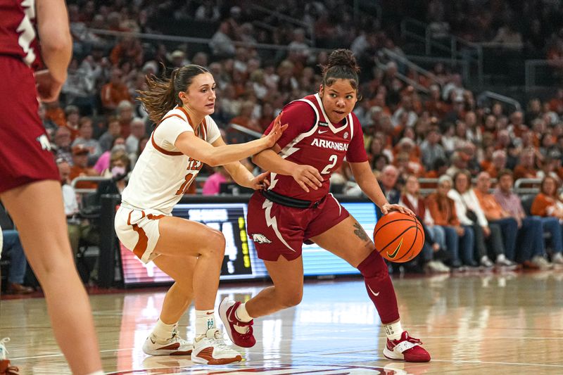 Jan 5, 2025; Austin, Texas, USA; Arkansas guard Kiki Smith (2) pushes past Texas Longhorns guard Shay Holle (10) during the game at Moody Center. Mandatory Credit: Aaron E. Martinez/USA TODAY Network via Imagn Images