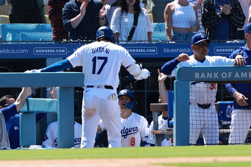 May 5, 2024; Los Angeles, California, USA;  Los Angeles Dodgers designated hitter Shohei Ohtani (17) is greeted by third base Enrique Hernandez (8) after hitting a home run during the eighth inning against the Atlanta Braves at Dodger Stadium. Mandatory Credit: Kiyoshi Mio-USA TODAY Sports