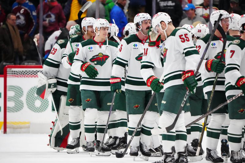 Jan 20, 2025; Denver, Colorado, USA; Members of the Minnesota Wild celebrate defeating the Colorado Avalanche at Ball Arena. Mandatory Credit: Ron Chenoy-Imagn Images