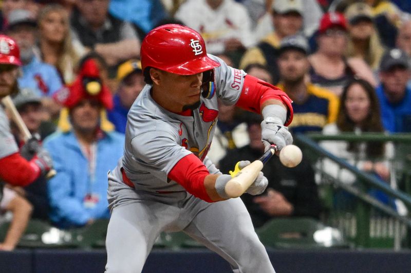 May 11, 2024; Milwaukee, Wisconsin, USA; St. Louis Cardinals shortstop Masyn Winn (0) hits a sacrifice bunt against the Milwaukee Brewers in the fifth inning at American Family Field. Mandatory Credit: Benny Sieu-USA TODAY Sports