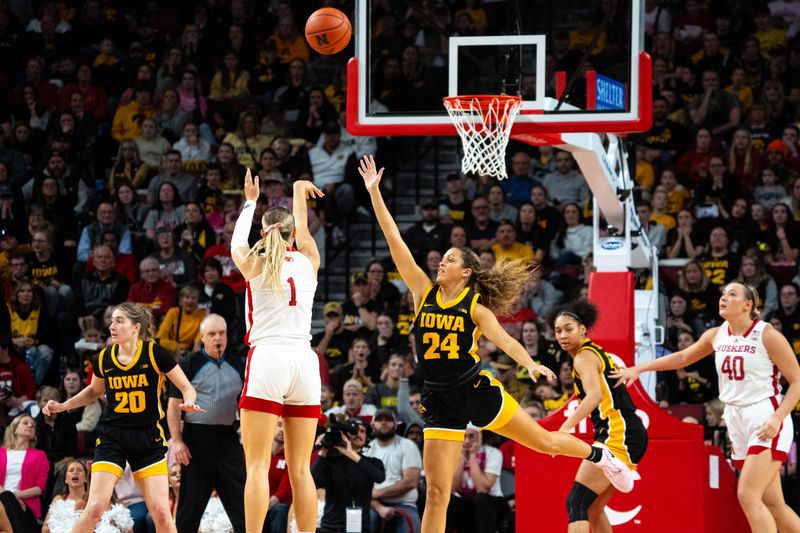 Feb 11, 2024; Lincoln, Nebraska, USA; Nebraska Cornhuskers guard Jaz Shelley (1) shoots a three point shot against Iowa Hawkeyes guard Gabbie Marshall (24) during the fourth quarter at Pinnacle Bank Arena. Mandatory Credit: Dylan Widger-USA TODAY Sports