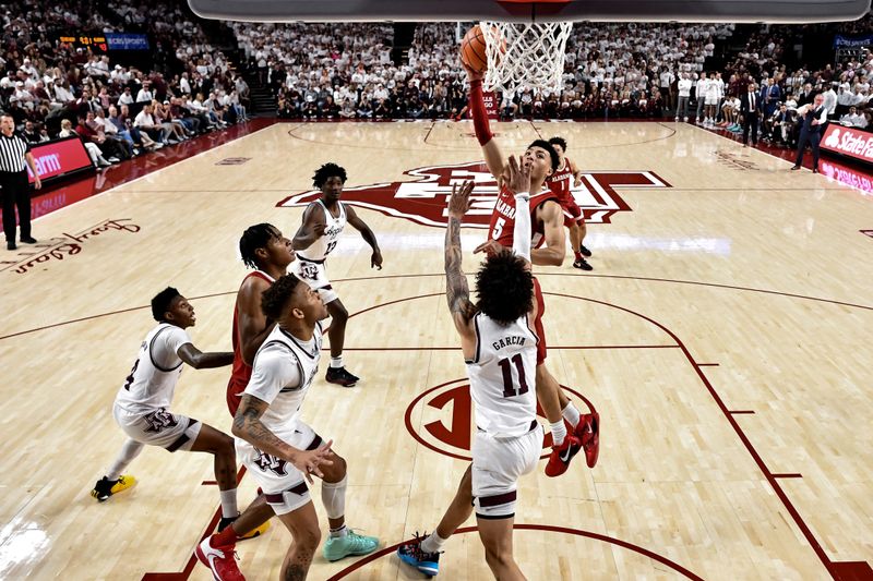 Mar 4, 2023; College Station, Texas, USA; Alabama Crimson Tide guard Jahvon Quinerly (5) shoots over Texas A&M Aggies forward Andersson Garcia (11) during the second half at Reed Arena. Mandatory Credit: Maria Lysaker-USA TODAY Sports