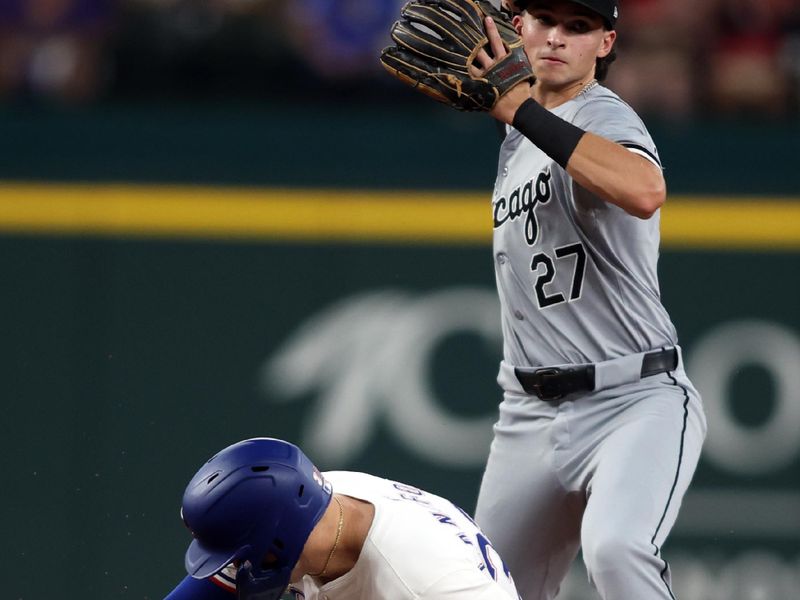 Jul 25, 2024; Arlington, Texas, USA;  Chicago White Sox second base Brooks Baldwin (27) turns a double play against Texas Rangers shortstop Corey Seager (5) in the third inning at Globe Life Field. Mandatory Credit: Tim Heitman-USA TODAY Sports