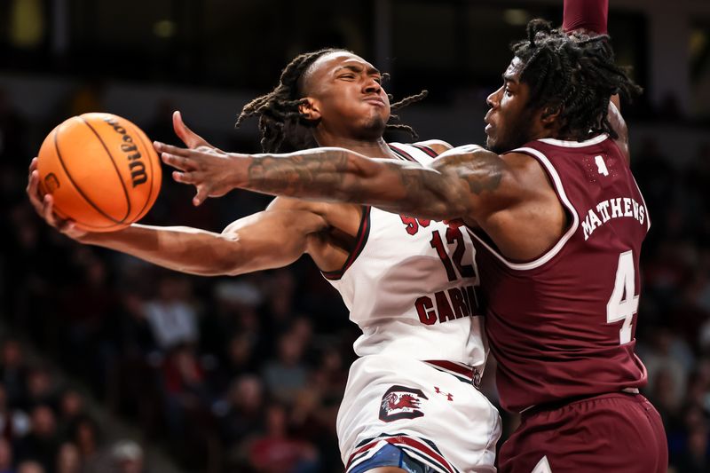 Jan 6, 2024; Columbia, South Carolina, USA; South Carolina Gamecocks guard Zachary Davis (12) attempts to pass around Mississippi State Bulldogs forward Cameron Matthews (4) in the first half at Colonial Life Arena. Mandatory Credit: Jeff Blake-USA TODAY Sports