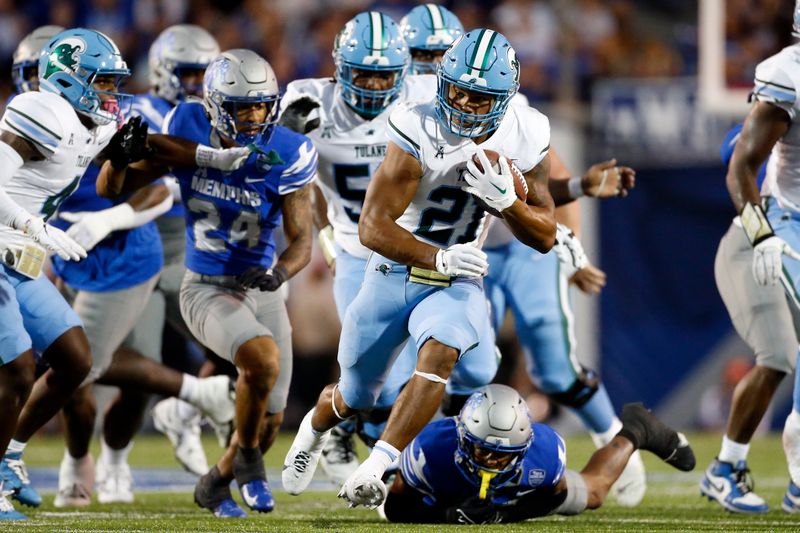 Oct 13, 2023; Memphis, Tennessee, USA; Tulane Green Wave running back Makhi Hughes (21) runs with the ball during the first half against the Memphis Tigers at Simmons Bank Liberty Stadium. Mandatory Credit: Petre Thomas-USA TODAY Sports