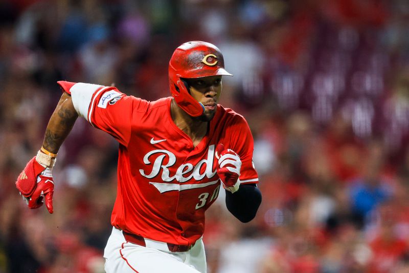 Sep 23, 2025; Cincinnati, Ohio, USA; Cincinnati Reds outfielder Will Benson (30) reaches first on a wild pitch in the seventh inning against the Pittsburgh Pirates at Great American Ball Park. Mandatory Credit: Katie Stratman-Imagn Images