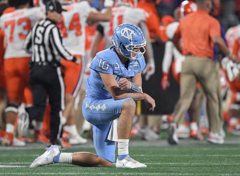 Dec 3, 2022; Charlotte, NC, USA; North Carolina Tar Heels quarterback Drake Maye (10) kneels after throwing an interception against the Clemson Tigers that was returned for a touchdown during the third quarter of the ACC Championship game at Bank of America Stadium. Mandatory Credit: Ken Ruinard-USA TODAY NETWORK