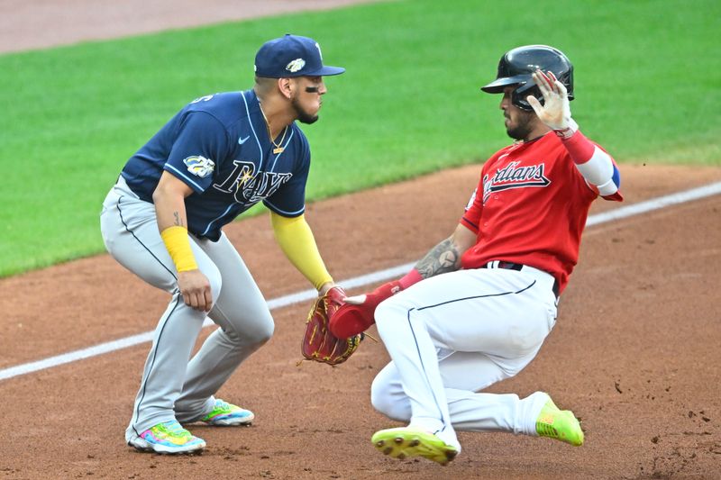 Sep 2, 2023; Cleveland, Ohio, USA; Cleveland Guardians shortstop Gabriel Arias (13) slides in to third base against Tampa Bay Rays third baseman Isaac Paredes (17) in the second inning at Progressive Field. Mandatory Credit: David Richard-USA TODAY Sports