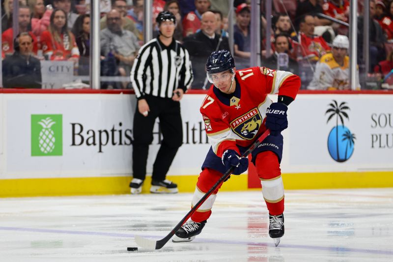 Nov 7, 2024; Sunrise, Florida, USA; Florida Panthers center Evan Rodrigues (17) moves the puck against the Nashville Predators during the second period at Amerant Bank Arena. Mandatory Credit: Sam Navarro-Imagn Images