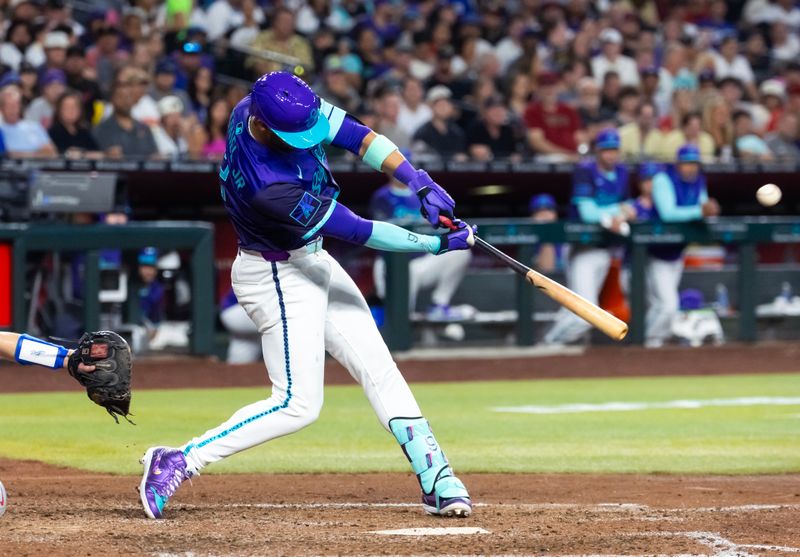 May 9, 2025; Phoenix, Arizona, USA; Arizona Diamondbacks outfielder Lourdes Gurriel Jr. hits a grand slam home run in the fifth inning against the Los Angeles Dodgers at Chase Field. Mandatory Credit: Mark J. Rebilas-Imagn Images