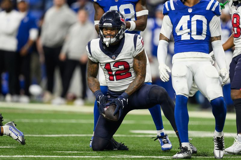 Houston Texans wide receiver Nico Collins (12) celebrates after a catch during an NFL football game against the Indianapolis Colts, Saturday, Jan. 6, 2024, in Indianapolis. (AP Photo/Zach Bolinger)