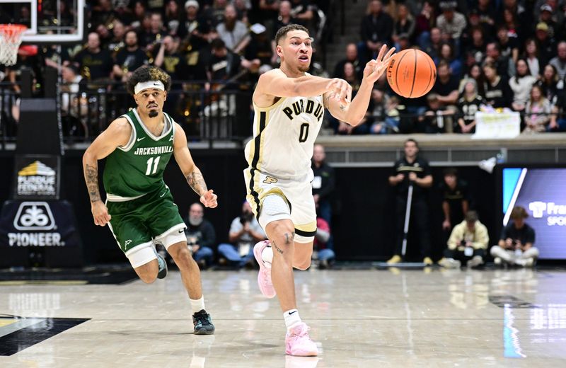 Dec 21, 2023; West Lafayette, Indiana, USA; Purdue Boilermakers forward Mason Gillis (0) passes the ball away from Jacksonville Dolphins guard Marcus Niblack (11) during the second half at Mackey Arena. Mandatory Credit: Marc Lebryk-USA TODAY Sports