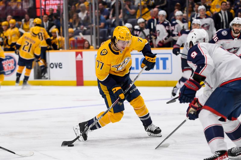 Apr 13, 2024; Nashville, Tennessee, USA; Nashville Predators right wing Luke Evangelista (77) takes a shot on goal against the Columbus Blue Jackets during the third period at Bridgestone Arena. Mandatory Credit: Steve Roberts-USA TODAY Sports