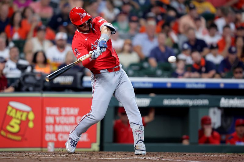 Sep 1, 2025; Houston, Texas, USA; Los Angeles Angels designated hitter Mike Trout (27) hits a single against the Houston Astros during the fourth inning at Daikin Park. Mandatory Credit: Erik Williams-Imagn Images