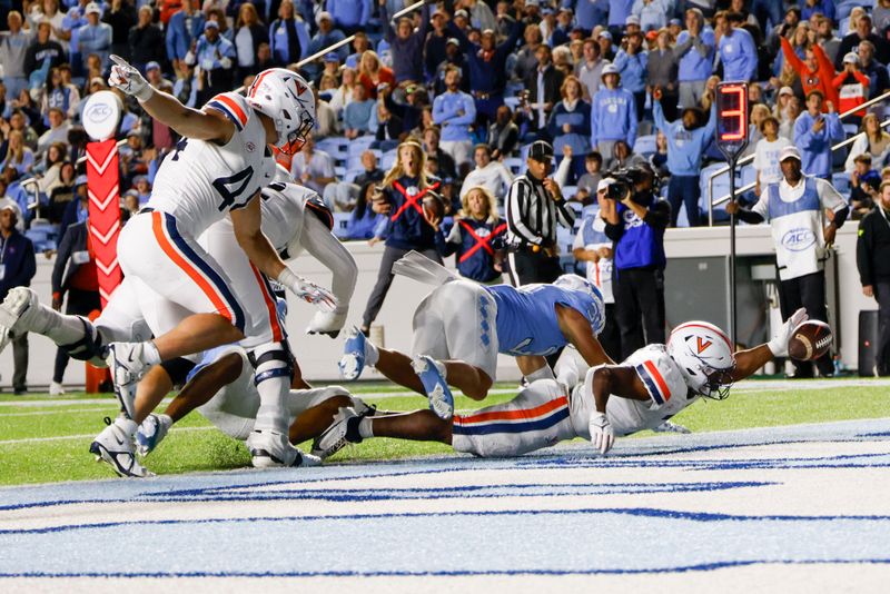 Oct 21, 2023; Chapel Hill, North Carolina, USA; Virginia Cavaliers running back Mike Hollins (7) fumbles the ball in the end zone against the North Carolina Tar Heels in the second half at Kenan Memorial Stadium. Mandatory Credit: Nell Redmond-USA TODAY Sports