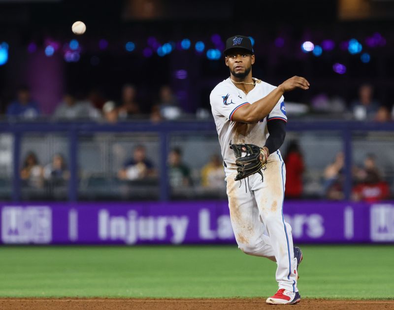 Jun 5, 2024; Miami, Florida, USA; Miami Marlins second baseman Otto Lopez (61) throws to first base to retire Tampa Bay Rays first baseman Yandy Diaz (not pictured) during the seventh inning at loanDepot Park. Mandatory Credit: Sam Navarro-USA TODAY Sports