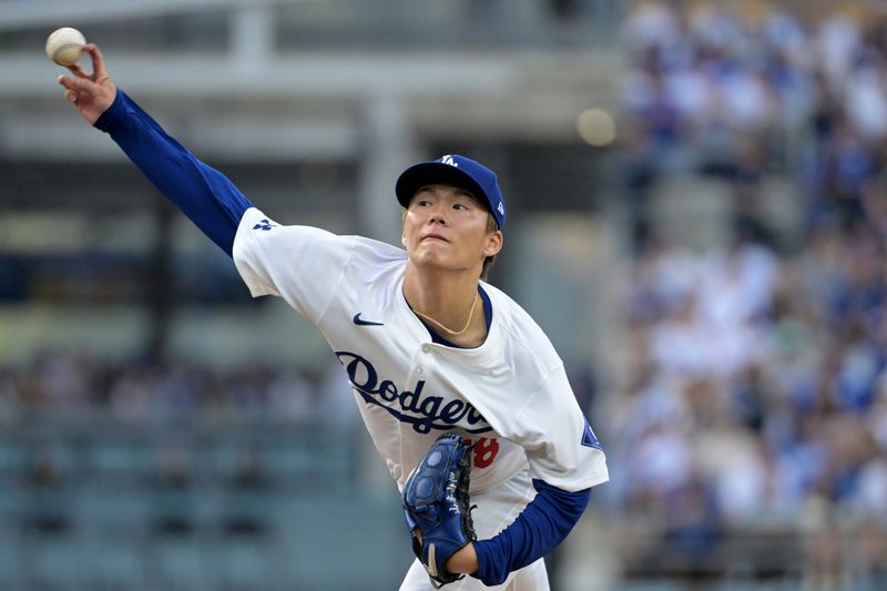 Oct 11, 2024; Los Angeles, California, USA; Los Angeles Dodgers pitcher Yoshinobu Yamamoto (18) pitches against the San Diego Padres in the second inning during game five of the NLDS for the 2024 MLB Playoffs at Dodger Stadium. Mandatory Credit: Jayne Kamin-Oncea-Imagn Images