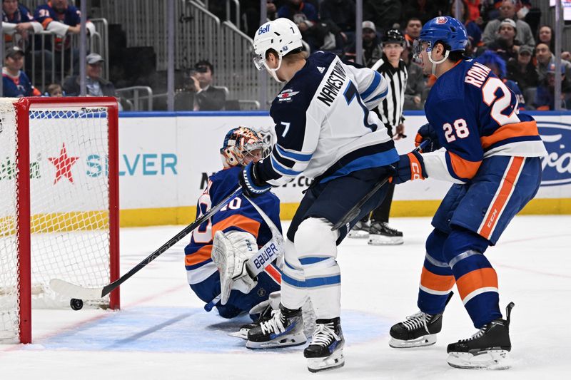 Mar 23, 2024; Elmont, New York, USA;  Winnipeg Jets center Vladislav Namestnikov (7) scores a goal past New York Islanders goaltender Semyon Varlamov (40) during the first period at UBS Arena. Mandatory Credit: Dennis Schneidler-USA TODAY Sports