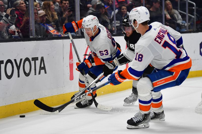 Mar 11, 2024; Los Angeles, California, USA; New York Islanders center Casey Cizikas (53) plays for the puck against Los Angeles Kings center Pierre-Luc Dubois (80) during the third period at Crypto.com Arena. Mandatory Credit: Gary A. Vasquez-USA TODAY Sports