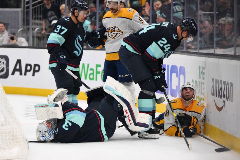 Nov 2, 2023; Seattle, Washington, USA; Seattle Kraken goaltender Philipp Grubauer (31) holds his shoulder after a collision with Nashville Predators center Liam Foudy (18) during the second period at Climate Pledge Arena. Mandatory Credit: Steven Bisig-USA TODAY Sports