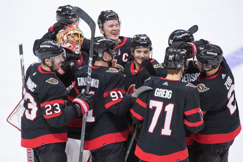 Dec 23, 2023; Ottawa, Ontario, CAN; The Ottawa Senators celebrate their win in overtime against the Pittsburgh Penguins at the Canadian Tire Centre. Mandatory Credit: Marc DesRosiers-USA TODAY Sports