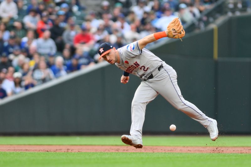 May 27, 2024; Seattle, Washington, USA; Houston Astros third baseman Alex Bregman (2) misses a ground ball hit by Seattle Mariners shortstop J.P. Crawford (3) (not pictured) during the first inning at T-Mobile Park. Mandatory Credit: Steven Bisig-USA TODAY Sports