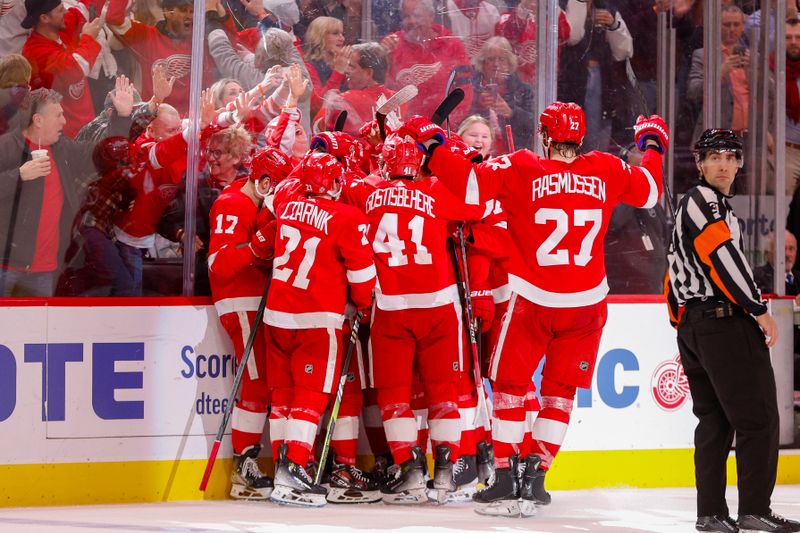 Mar 19, 2024; Detroit, Michigan, USA; The Detroit Red Wings celebrate a game winning goal by Detroit Red Wings right wing Patrick Kane (88) during an overtime period at Little Caesars Arena. Mandatory Credit: Brian Bradshaw Sevald-USA TODAY Sports