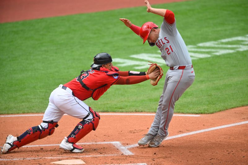 May 5, 2024; Cleveland, Ohio, USA; Los Angeles Angels catcher Matt Thaiss (21) tries to avoid a tag by Cleveland Guardians catcher Bo Naylor (23) before being tagged out in the second inning at Progressive Field. Mandatory Credit: David Richard-USA TODAY Sports