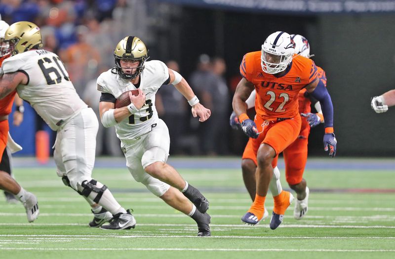 Sep 15, 2023; San Antonio, Texas, USA; Army Black Knights quarterback Bryson Daily (13) caries the ball in front of UTSA Roadrunners linebacker Rodney Groce Jr. (22) during the first half at the Alamodome. Mandatory Credit: Danny Wild-USA TODAY Sports