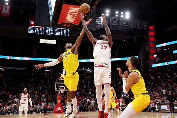 HOUSTON, TEXAS - DECEMBER 26: Tari Eason #17 of the Houston Rockets and Buddy Hield #7 of the Indiana Pacers battle for a rebound in the second half at Toyota Center on December 26, 2023 in Houston, Texas.  NOTE TO USER: User expressly acknowledges and agrees that, by downloading and or using this photograph, User is consenting to the terms and conditions of the Getty Images License Agreement. (Photo by Tim Warner/Getty Images)