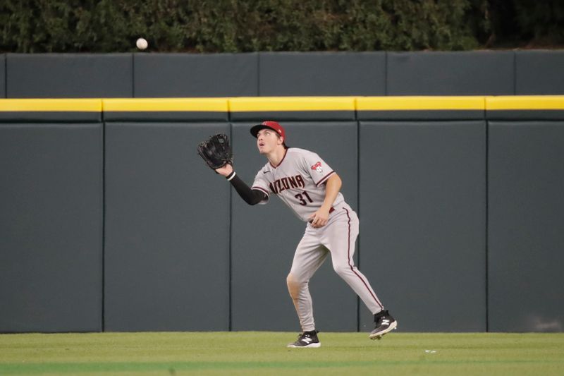 Jun 9, 2023; Detroit, Michigan, USA; Arizona Diamondbacks outfielder Jake McCarthy (31) makes a catch during the game against the Detroit Tigers at Comerica Park. Mandatory Credit: Brian Bradshaw Sevald-USA TODAY Sports