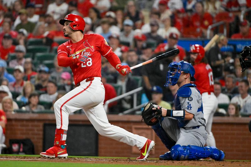 Jun 6, 2025; St. Louis, Missouri, USA;  St. Louis Cardinals third baseman Nolan Arenado (28) hits a single against the Los Angeles Dodgers during the second inning at Busch Stadium. Mandatory Credit: Jeff Curry-Imagn Images